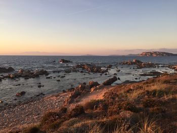 Scenic view of sea against clear sky at sunset