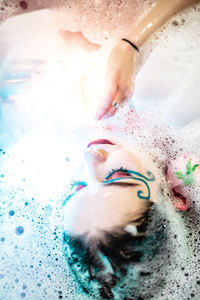 Close-up of wet woman in bathtub