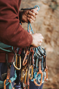 Man sorting out carabiners to prepare for rock climbing