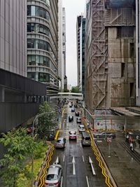 Traffic on road amidst buildings in city