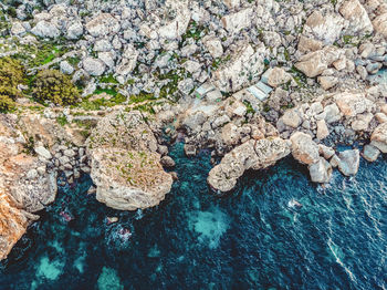 High angle view of rocks by sea