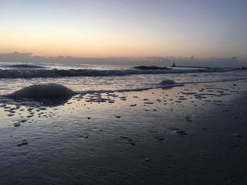 Scenic view of beach at sunset