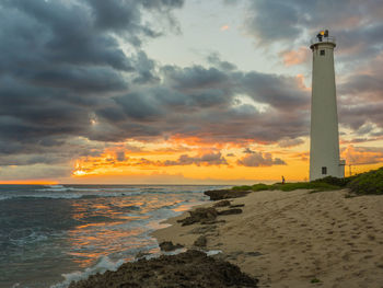 Scenic view of beach against cloudy sky