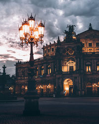 Statue in city at night