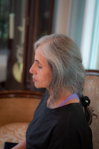 Close-up of senior woman with eyes closed at home