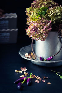 Close-up of vegetable by potted plant on table