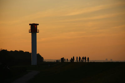 Silhouette people against sky during sunset