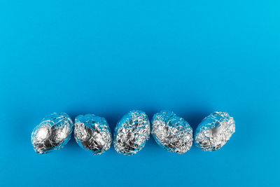 High angle view of candies against blue background