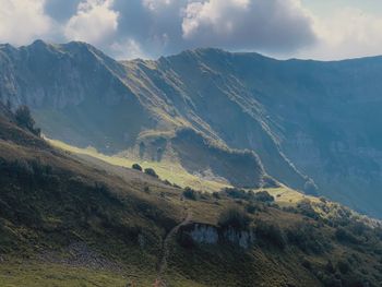 Scenic view of mountains against cloudy sky