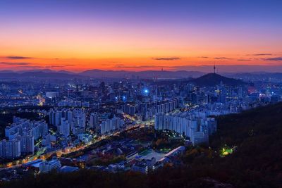 High angle view of illuminated buildings against sky at sunset