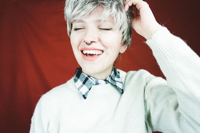 Close-up of happy mid adult woman with piercing