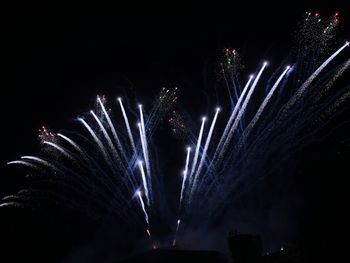 Low angle view of firework display at night