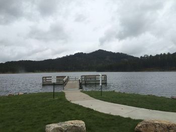 Scenic view of calm lake with mountains in background