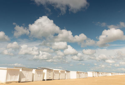 Sandy beach of calais in summer with its beach cabins and view of the english channel