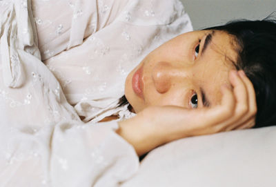 Close-up portrait of baby sleeping on bed