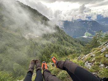 Low section of man sitting on mountain