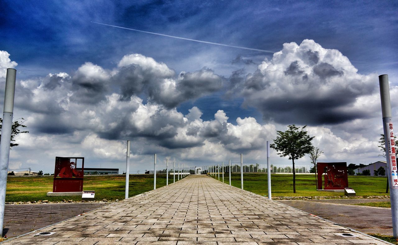 sky, the way forward, cloud - sky, cloudy, built structure, building exterior, architecture, cloud, diminishing perspective, empty, road, vanishing point, tree, overcast, house, tranquility, weather, nature, grass, footpath