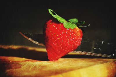 Close-up of red fruit over black background