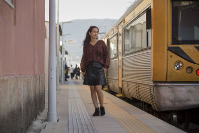 Rear view of woman standing in train