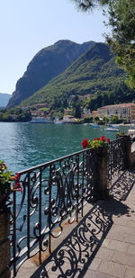 Scenic view of lake by mountains against clear sky