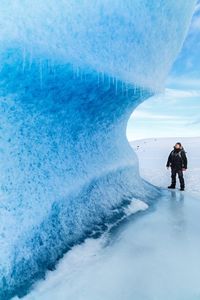 People standing in sea during winter