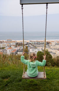 Boy swinging at playground