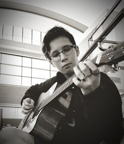 Portrait of young man playing guitar