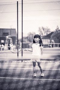 Full length of woman playing with ball