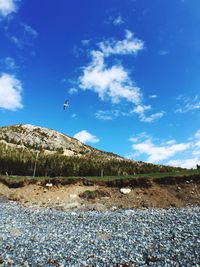 Scenic view of mountain against blue sky