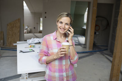 Young woman using mobile phone at home