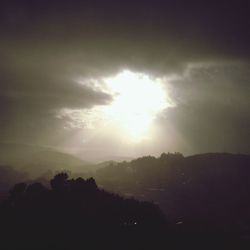 Scenic view of mountains against cloudy sky