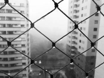 Close-up of chainlink fence against sky