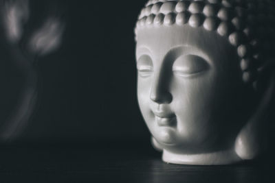 Close-up of statue against black background