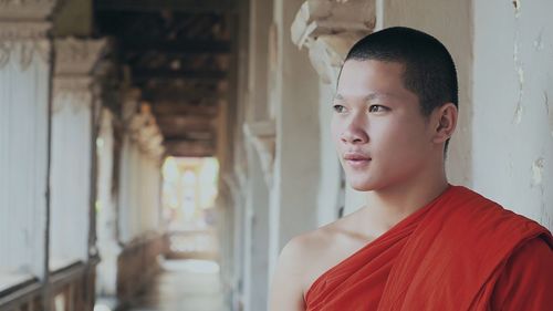 Close-up of monk standing in corridor