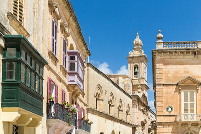 Low angle view of old building against blue sky