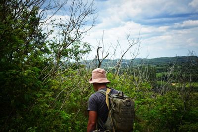 Rear view of man on land against sky