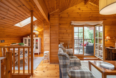 Beautiful interior of a living room with view of terrace and dining area in a wooden house