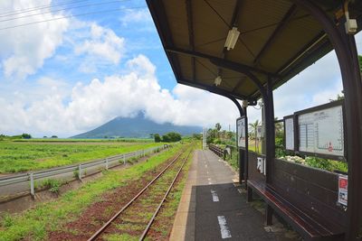 Railroad track amidst trees against sky