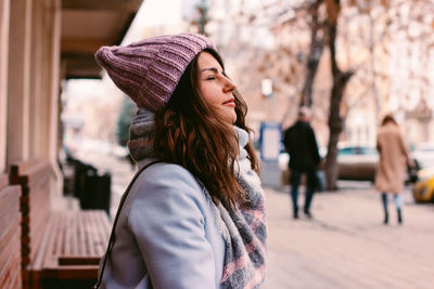 Midsection of woman standing in city