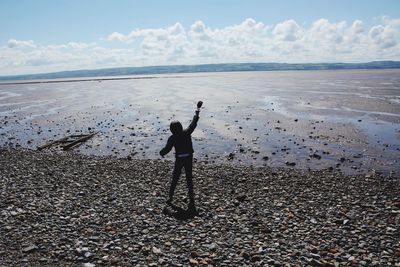 Full length of man on beach against sky