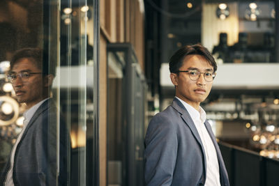Portrait of businessman using mobile phone in office