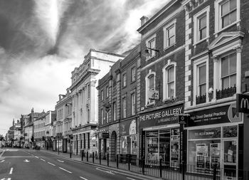 Street by building against sky in city