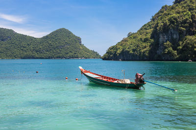 Man on boat in sea against sky