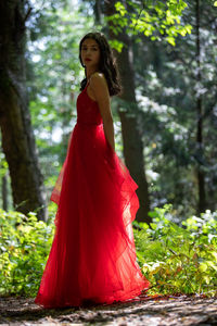 Young woman standing in forest