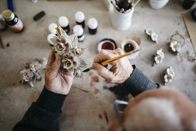 Senior man decorating ceramics in his spare time