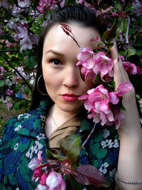 Portrait of woman with pink flower