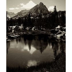 Scenic view of river and mountains against sky