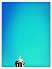 High section of building against blue sky