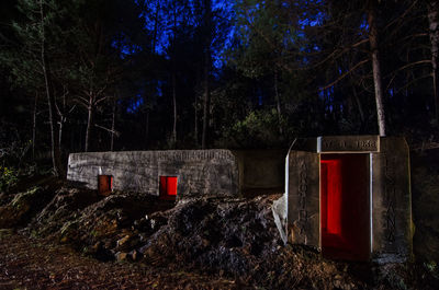 View of a bunker against trees at night