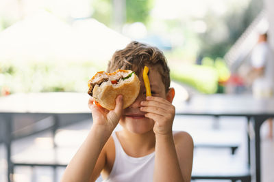 Close-up of hand holding burger